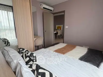 Modern bedroom with stylish decor and air conditioning in a contemporary apartment.