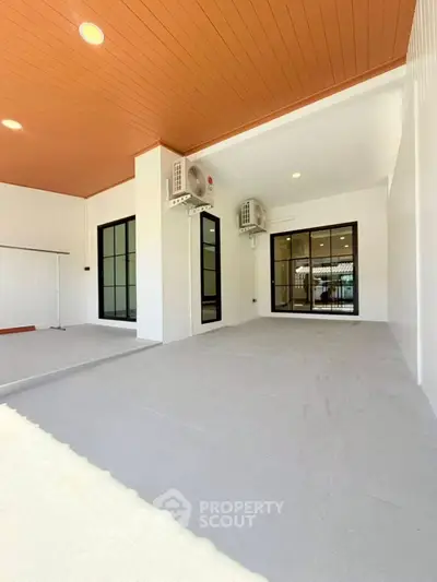 Spacious modern patio with sleek design and air conditioning units, perfect for outdoor relaxation.