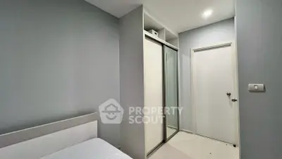 Modern bedroom with sleek sliding closet doors and minimalist design