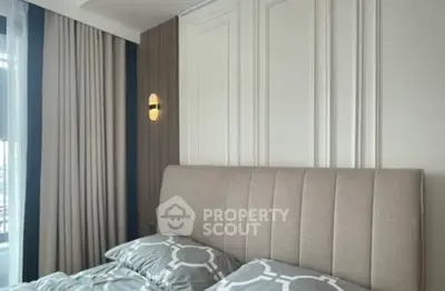 Elegant bedroom with modern decor and stylish lighting, featuring a comfortable bed and chic curtains.
