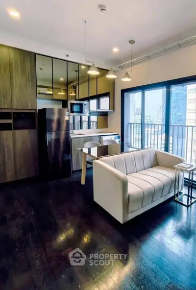 Modern open-layout kitchen and living room with city view balcony in luxury apartment.