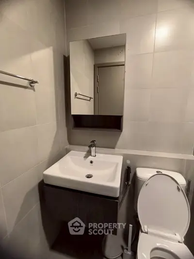 Modern bathroom with sleek sink and toilet in minimalist design
