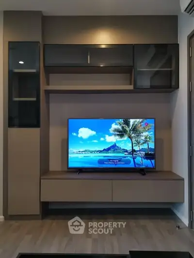 Modern living room with sleek TV unit and tropical screen display