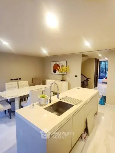 Modern kitchen with sleek island and dining area in open layout design