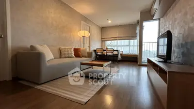 Spacious modern living room with cozy sofa and large window view