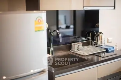 Modern kitchen with sleek countertops and stainless steel appliances