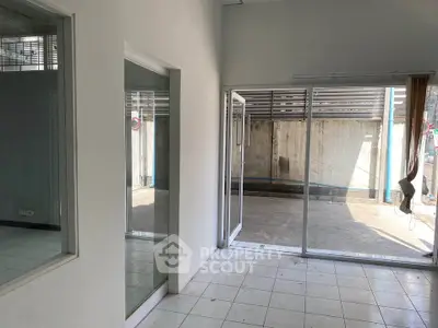 Spacious interior with large windows and sliding doors leading to a private outdoor area.