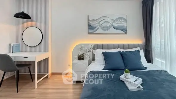 Modern bedroom with stylish decor, featuring a cozy bed, elegant lighting, and a chic study area.