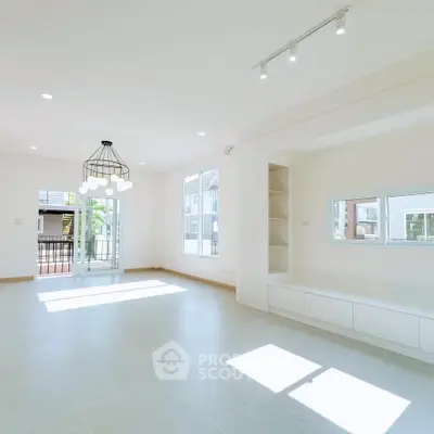 Spacious and bright living room with modern lighting and large windows.