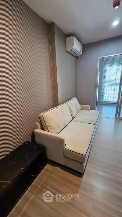 Modern living room with stylish sofa and air conditioning in a contemporary apartment.