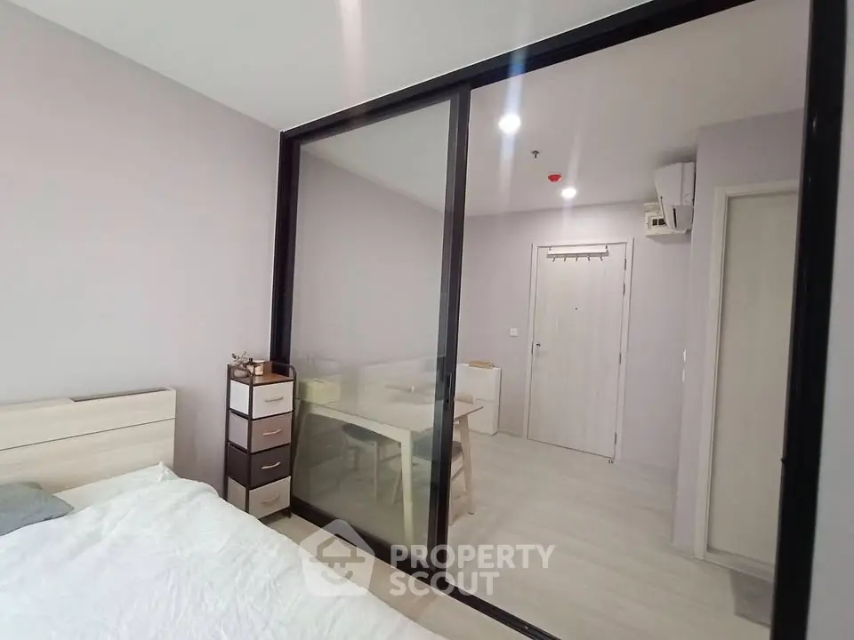 Modern bedroom with sliding glass doors and minimalist decor