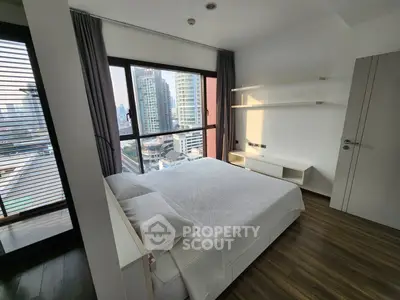 Modern bedroom with city view and sleek wooden flooring