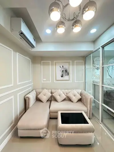 Elegant living room with plush sectional sofa and modern lighting, perfect for cozy gatherings.