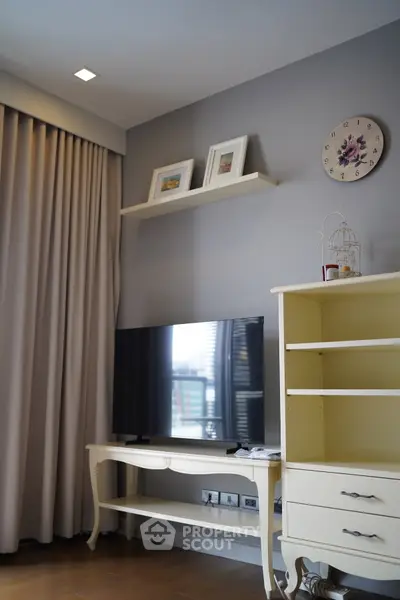 Charming living room with elegant decor and modern TV setup, perfect for cozy evenings.