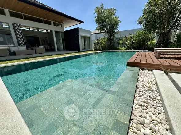 Luxurious modern villa with stunning private pool and lush garden, perfect for relaxation and entertainment.