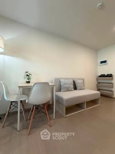 Modern living room with cozy sofa and dining area in minimalist design