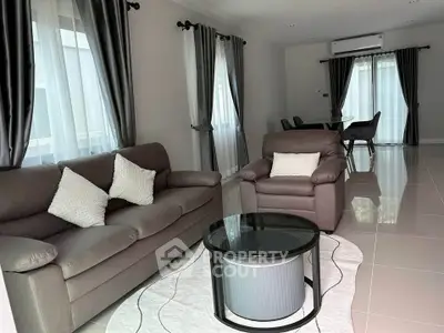 Elegant living room with modern furniture and natural light, perfect for relaxation and entertaining.