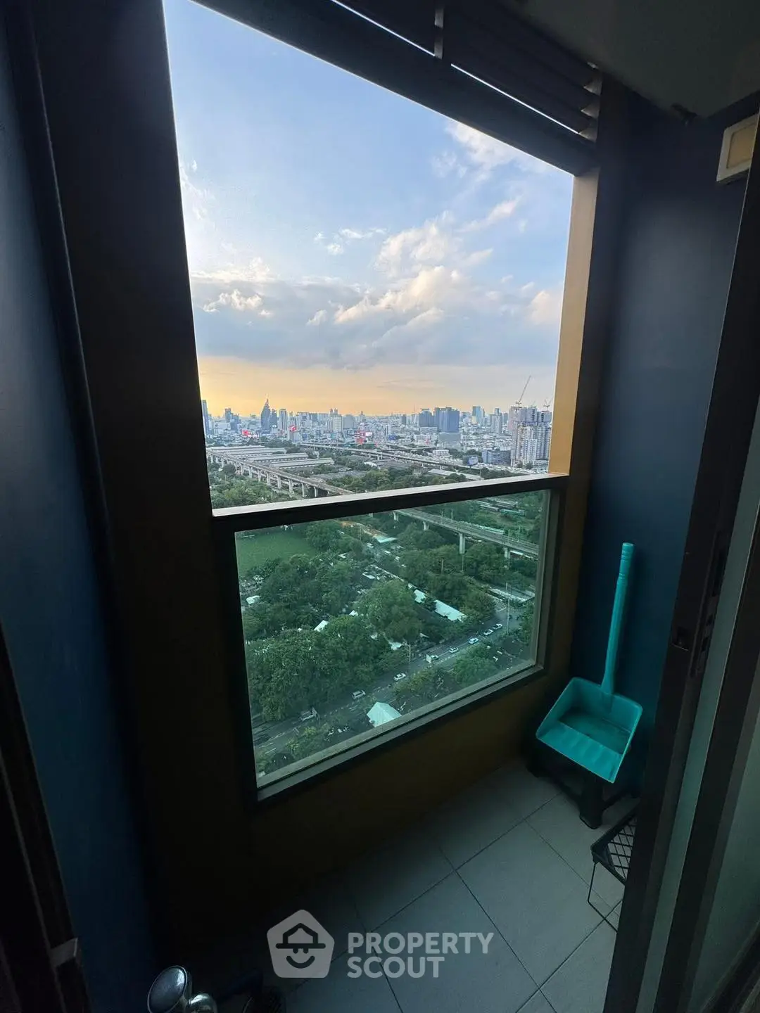 Stunning cityscape view from a high-rise balcony at sunset, perfect for urban living.