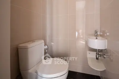 Modern minimalist bathroom with sleek fixtures and neutral tiles