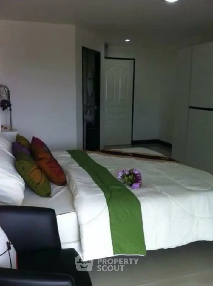 Cozy bedroom with modern decor and comfortable bedding in a stylish apartment.