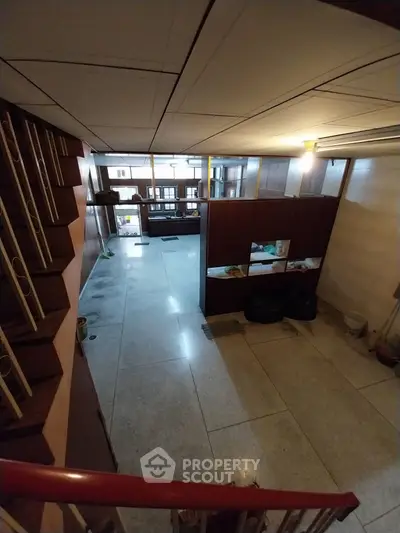 Spacious interior with unique staircase and open layout, ideal for creative renovation.