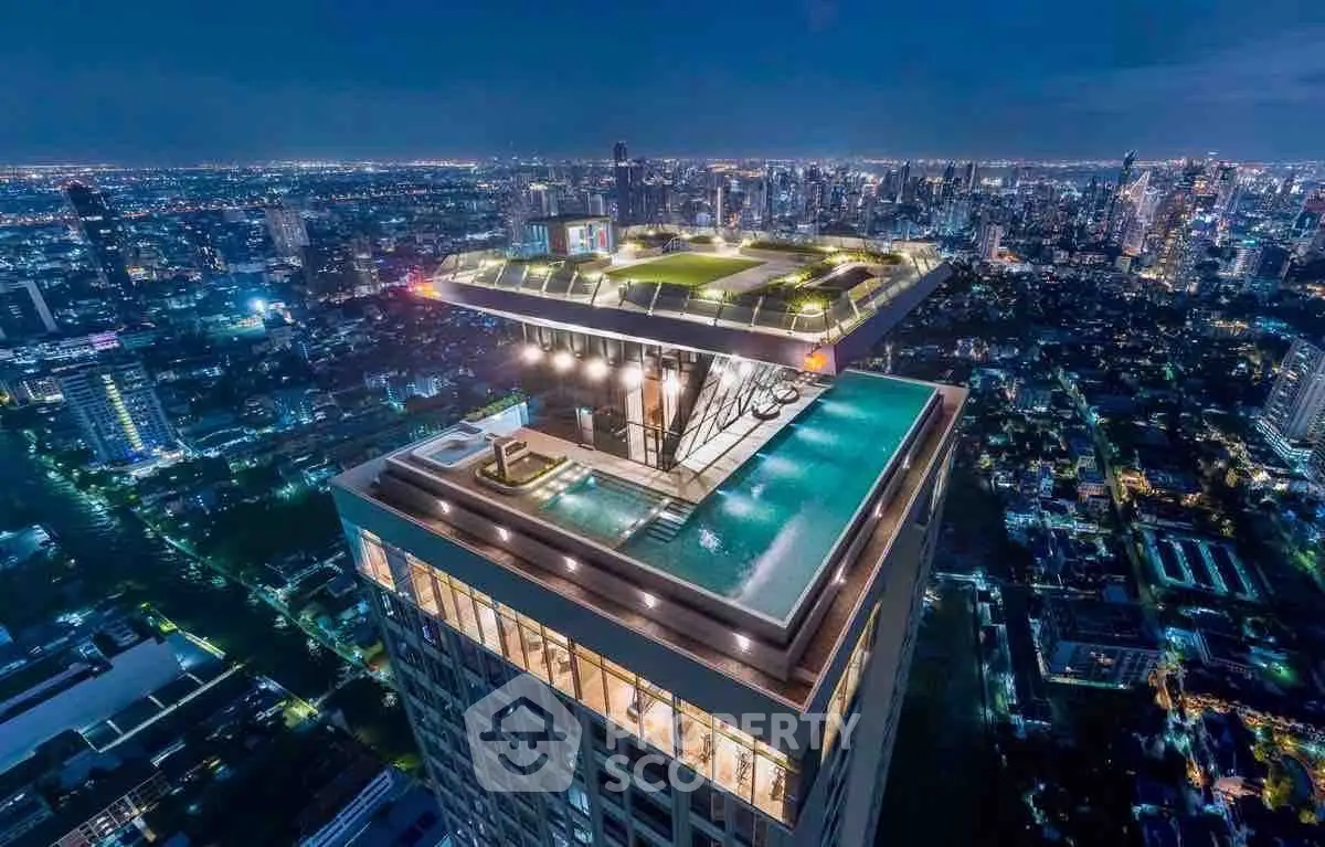 Stunning rooftop pool with panoramic city views at night in a luxury high-rise building.