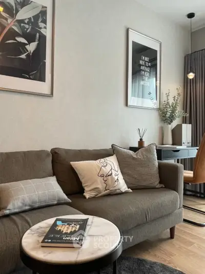 Stylish living room with modern decor, cozy sofa, and elegant wall art in a contemporary apartment.