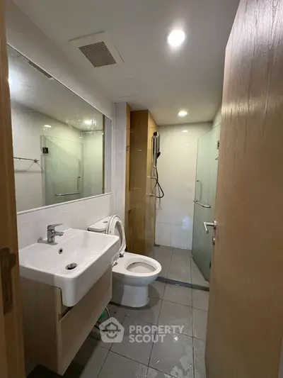 Modern bathroom with glass shower and sleek fixtures