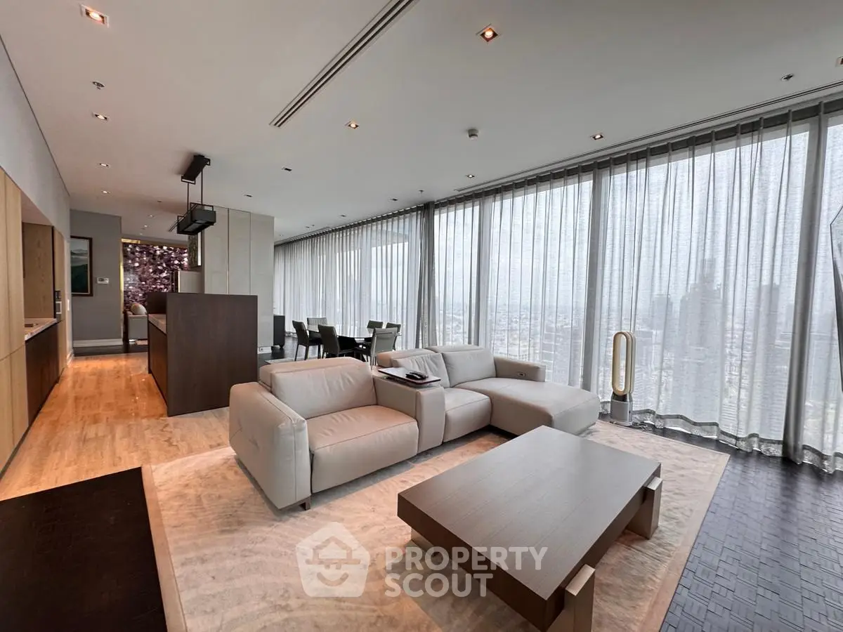 Luxurious modern living room with panoramic city views and elegant furnishings.