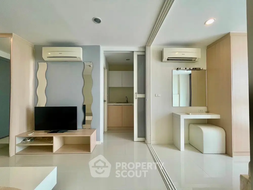 Modern living room with sleek design, featuring air conditioning and stylish mirrors, perfect for urban living.