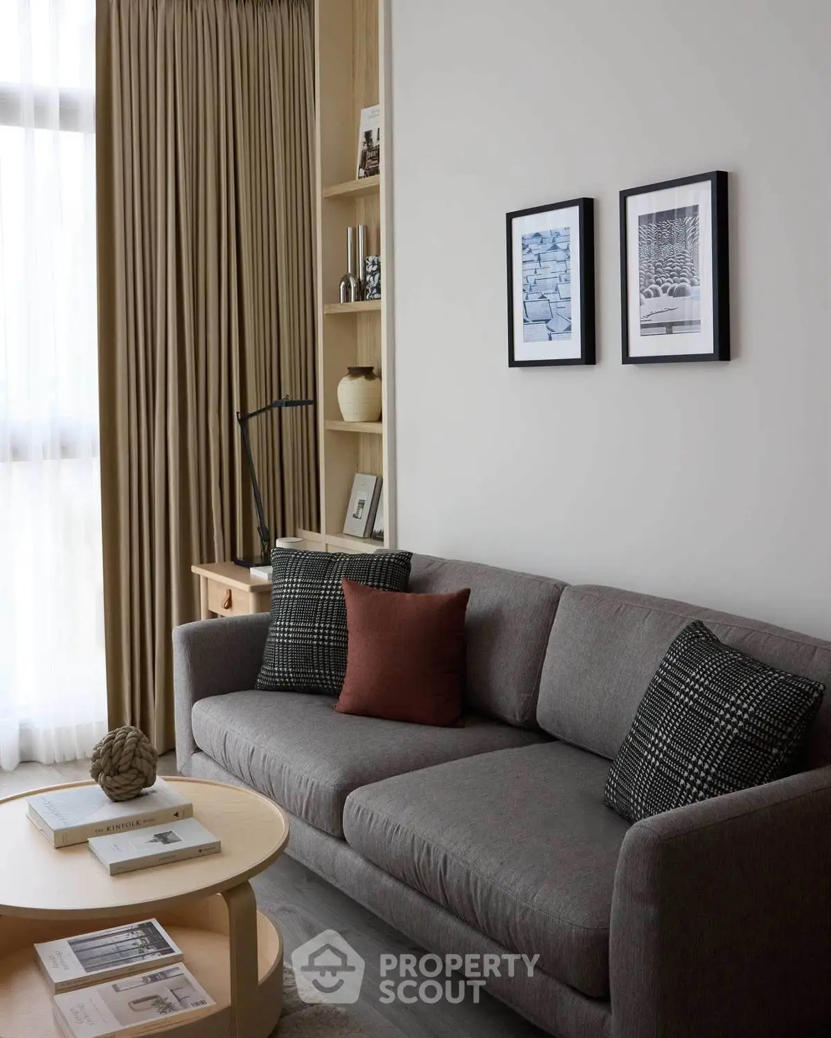 Stylish living room with modern gray sofa, chic decor, and natural light