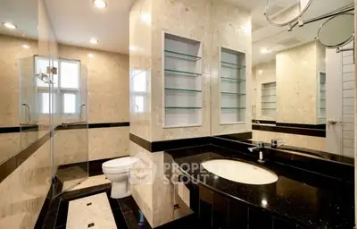 Luxurious bathroom with elegant marble finishes and modern fixtures.