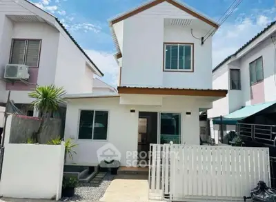 Charming two-story white house with modern design and gated entrance in a suburban neighborhood.