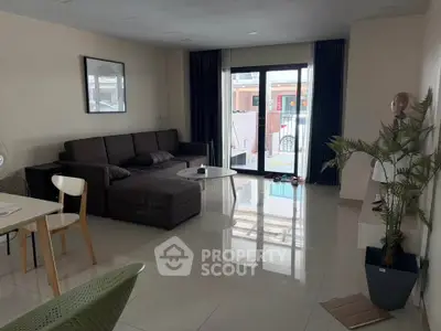 Spacious modern living room with large windows and stylish furniture