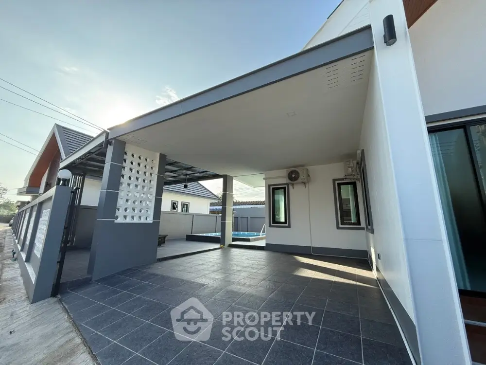 Modern house exterior with covered parking and sleek design