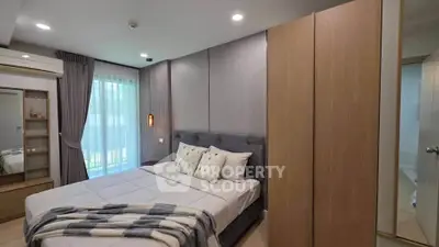 Modern bedroom with stylish decor and ample natural light