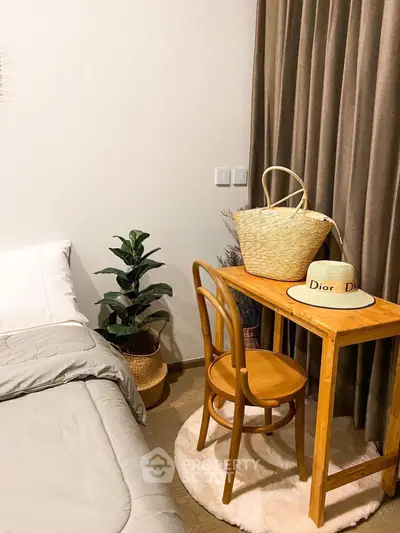 Cozy bedroom corner with wooden desk, chair, and stylish decor