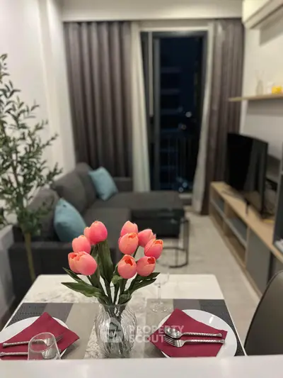 Chic modern living room with elegant dining setup and cozy seating area, perfect for urban living.