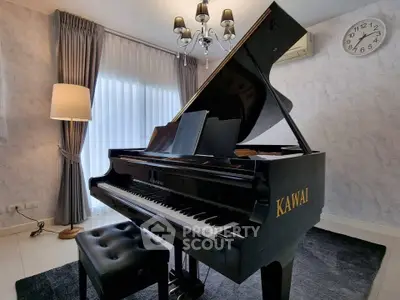 Elegant living room with grand piano and stylish decor, perfect for music lovers.