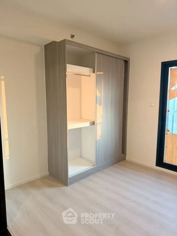 Modern bedroom with sleek built-in wardrobe and natural light