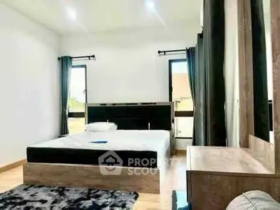 Spacious modern bedroom with large windows and stylish decor