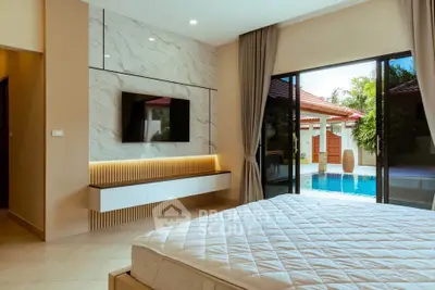 Luxurious bedroom with pool view, modern decor, and large sliding doors.