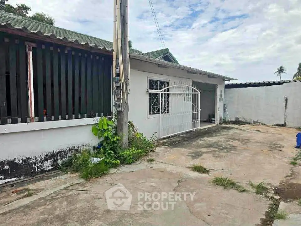 Charming single-story home with gated entrance and spacious driveway, perfect for family living.