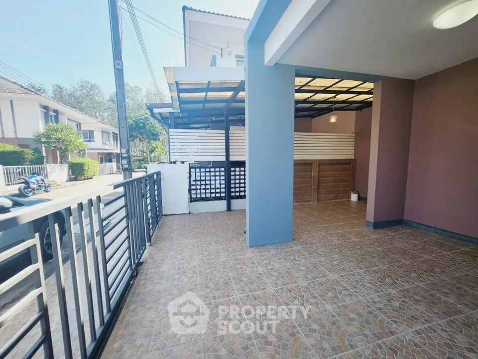 Spacious modern patio with tiled flooring and covered parking area
