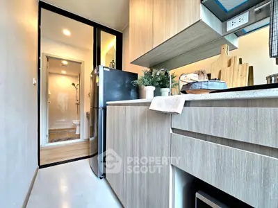 Modern kitchen with sleek cabinetry and appliances in a compact layout