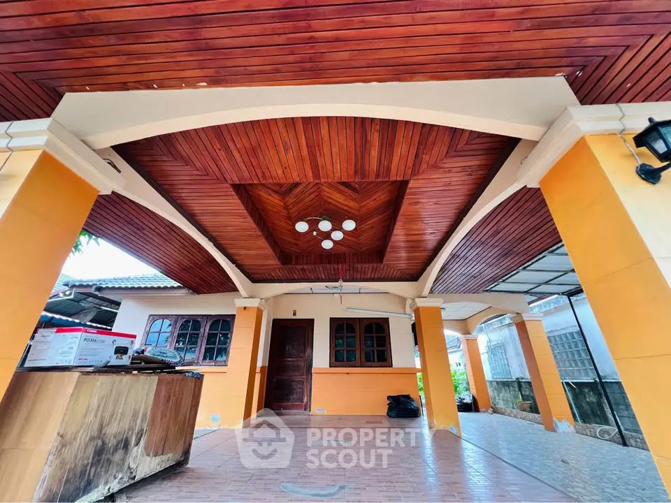 Stunning wooden ceiling porch with elegant lighting and spacious tiled flooring.