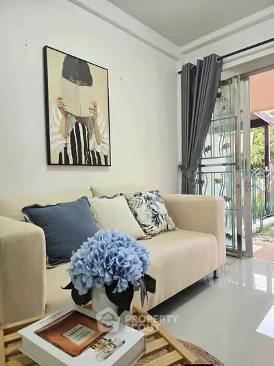 Charming living room with cozy sofa, elegant decor, and garden view.