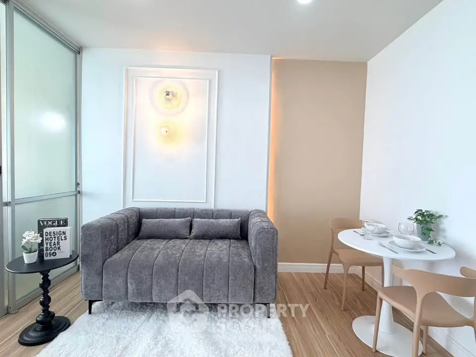 Modern living room with stylish gray sofa and chic dining area, perfect for urban living.