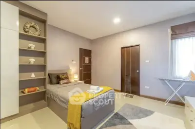 Modern bedroom with stylish decor and ample storage space