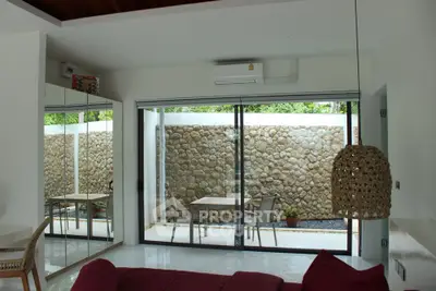 Modern living room with glass doors opening to a private patio